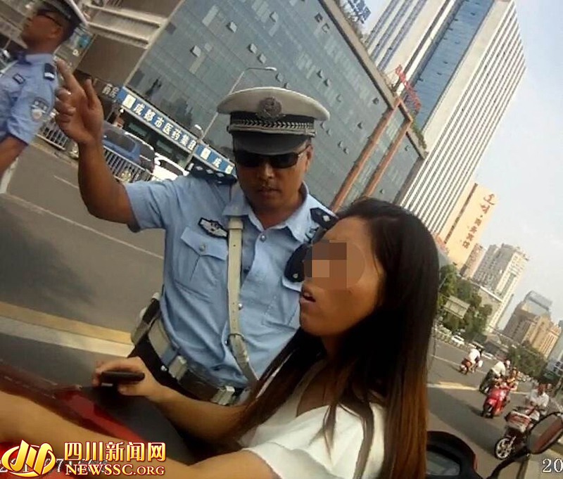 高清:成都一女子骑电瓶车载人被拦下 怒踹交警
